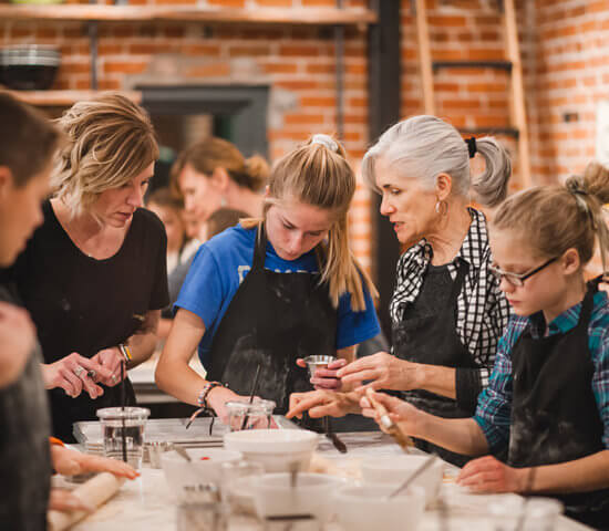 Three generations of women in a family cooking class at Ginger and Baker Teaching Kitchen in Fort Collins