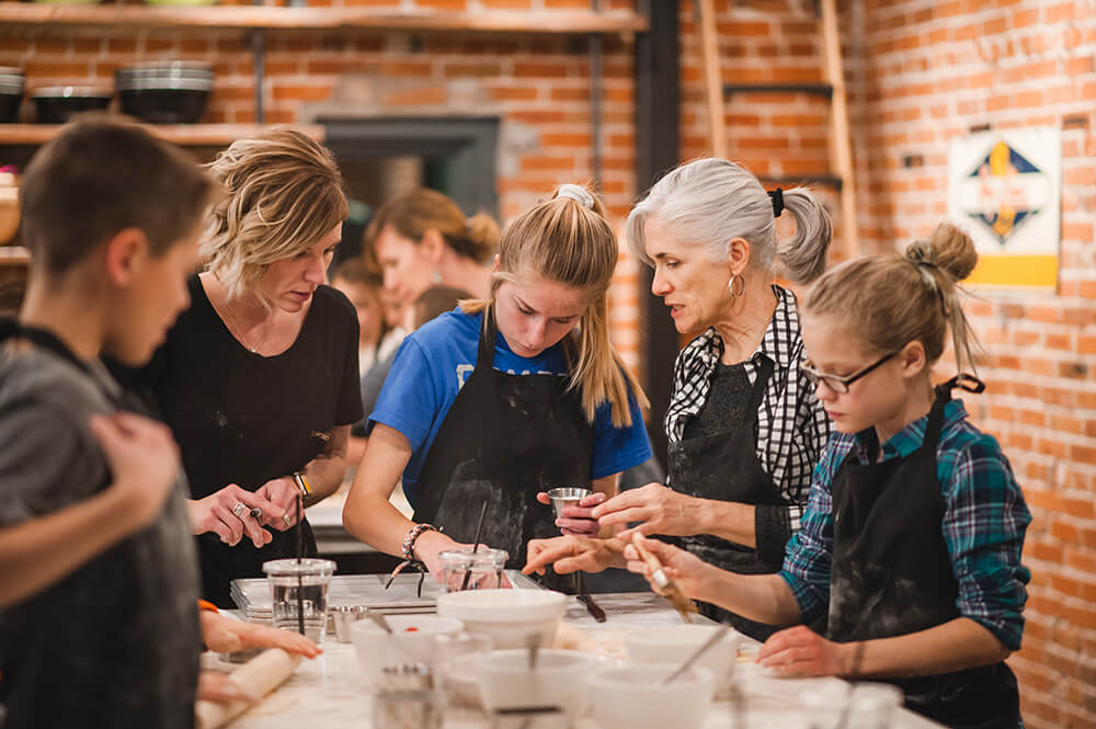 Three generations of women in a family cooking class at Ginger and Baker Teaching Kitchen in Fort Collins