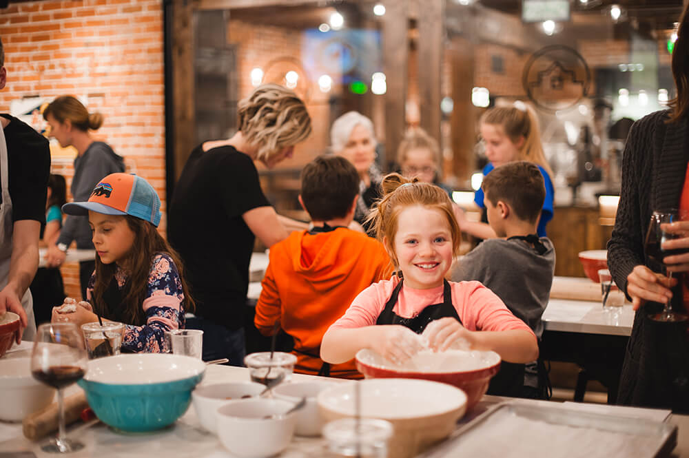 Cute kid enjoying a children's cooking class in the Ginger and Baker Teaching Kitchen