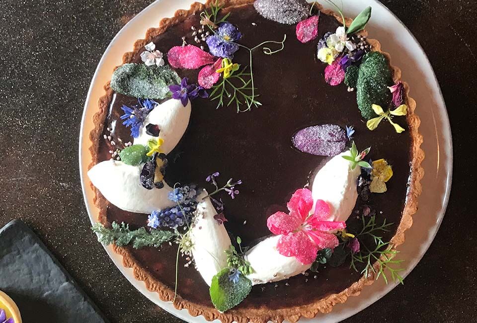 Learn how to make candied flowers chocolate tart at Ginger and Baker in Fort Collins Colorado