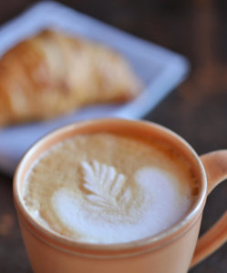 Creamy latte and housemade croissant in the Coffee Shop at Ginger and Baker