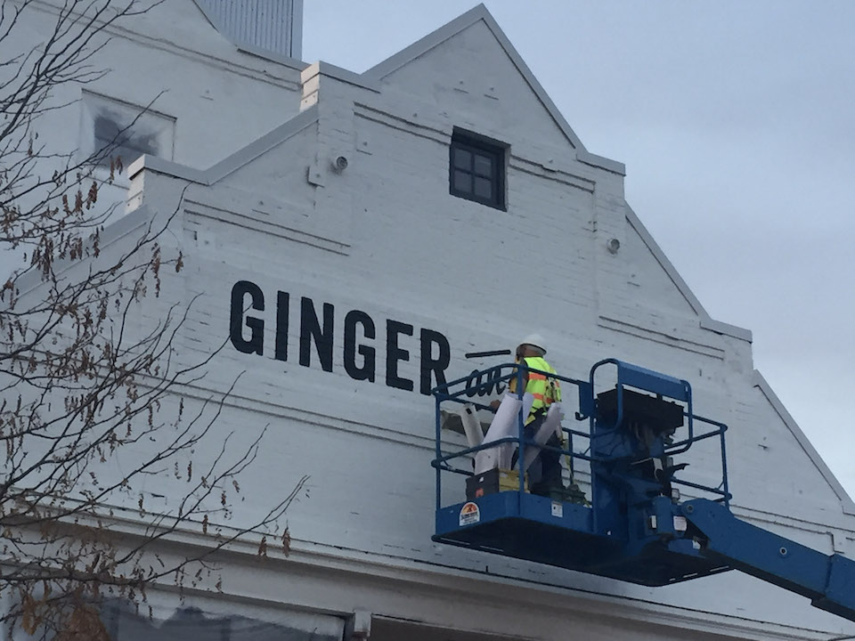 Painting the sign at Ginger and Baker's historic grain mill in Fort Collins