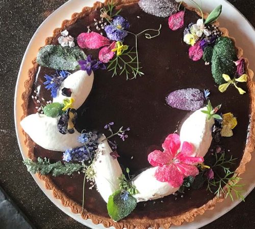Learn how to make candied flowers chocolate tart at Ginger and Baker in Fort Collins Colorado