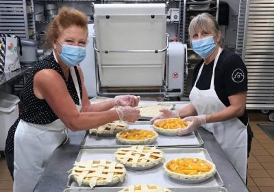 Ginger Graham and Chef Deb Traylor making pies for Fort Collins Rotary Fundraiser