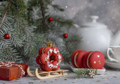 Christmas festive composition with macaron macaroon cookies, Christmas balls and tea set in pink