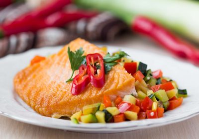 Fried fillet of red fish salmon with roasted vegetables, zucchini, pepper, beautiful dish