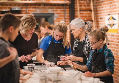 Three generations of women in a family cooking class at Ginger and Baker Teaching Kitchen in Fort Collins