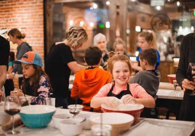 Cute kid enjoying a children's cooking class in the Ginger and Baker Teaching Kitchen